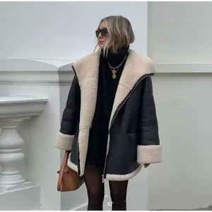 Oversized black faux leather biker jacket with plush beige shearling lining and wide lapels