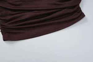 Detail of professional double-needle stitching and pleated texture on brown knit fabric