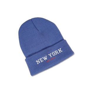 Detailed close-up of navy blue NEW YORK embroidery on a stylish knitted beanie hat