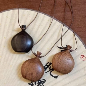 Bohemian wax rope necklace with handcrafted wood kettle pendants in brown and black