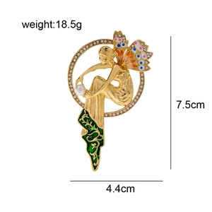 Vintage gold fairy brooch with green enamel wings and white pearl detail for women