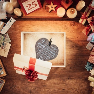 Wooden heart plaque friendship ornament with quote in a gift box on festive desk