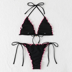 Detail of black bikini with pink ruffle trim and side-tie adjustable design