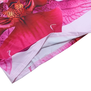 Close-up of double-stitched hem and floral orchid pattern on long backless dress