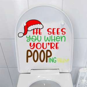 Funny Christmas toilet seat decal featuring a red Santa hat and festive humorous text