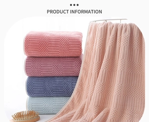 Detail view of thickened coral fleece towels with waffle texture in multiple colors