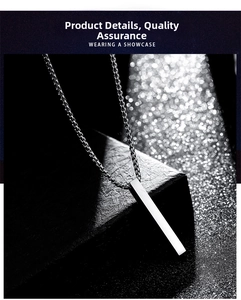 Close-up of minimalist silver stick pendant with a robust box chain on leather background