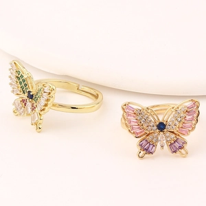 Close-up of gold butterfly ring with colorful zircons and adjustable open band