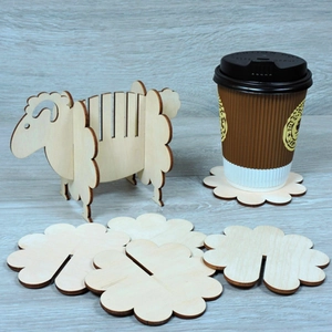 Creative sheep-shaped wooden coaster set with cloud-like pads on a minimalist tabletop