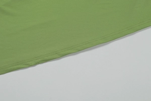 Macro detail of avocado green hem featuring professional double-needle stitching quality
