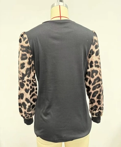Rear view of women's black long sleeve T-shirt featuring leopard print patchwork sleeves