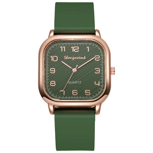 Detail of square quartz watch with dark green textured dial and rose gold numerals