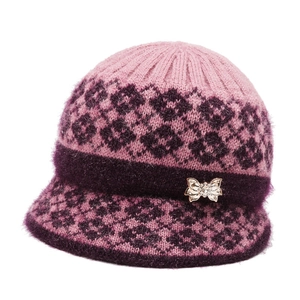 Women's pink knit beanie with purple faux fur trim and crystal bow for winter warmth