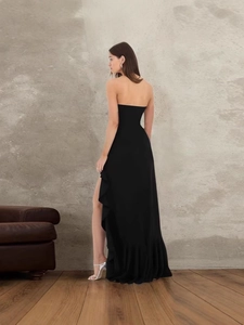 Elegant strapless black evening dress with side slit and ruffle hem for a classic formal look