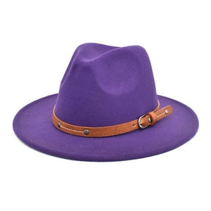 Detail of purple felt fedora hat featuring a brown faux leather band with metal buckle
