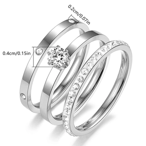 Three-piece titanium steel ring set with zircon accents and a six-prong setting on white background