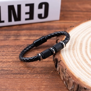Detail of black braided leather bracelet with silver metal rings and magnetic clasp