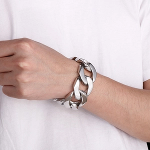Close-up of thick silver Cuban link bracelet on wrist with high polish finish