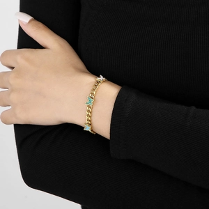 Detail of gold Cuban chain bracelet featuring colorful enamel butterflies on wrist