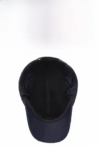 Detail of dark blue winter baseball cap with quilted lining and adjustable ear flaps