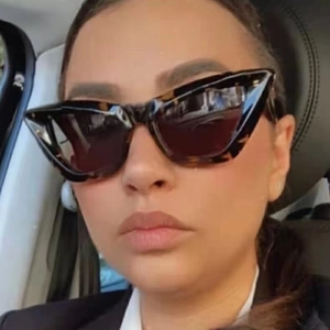 Fashionable tortoise shell cat eye sunglasses with brown lenses worn by a model