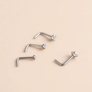 L-shaped G23 titanium nose studs featuring sparkling zircon stones in four diverse sizes