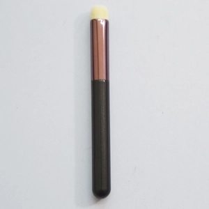 Detail of round silicone lip brush with white bristles, rose gold ferrule and black handle