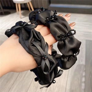 Elegant black pleated headbands with silk texture, crystal beads and a decorative bow