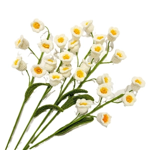 Handmade crochet Lily of the Valley bouquet with white knit flowers on white background