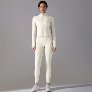 Close-up of off-white yoga set showing slim-fit zipper jacket and thumbhole sleeves