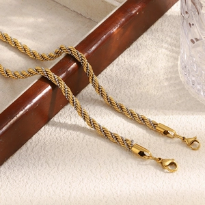 Close-up of dual-tone gold and silver twisted rope chain with a metal lobster clasp detail
