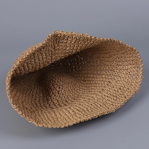 Close-up of the tight hand-woven texture and interior craftsmanship of this raffia straw hat