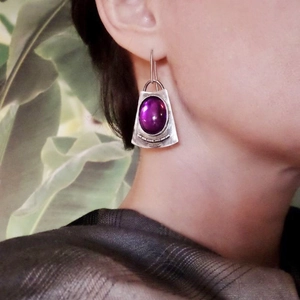 Vintage silver drop earrings with oval purple gemstone and elegant green leaf background