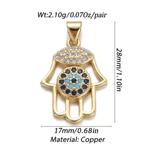 Detail of Hamsa hand pendant in gold-plated copper with blue and clear cz stones