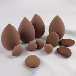 Detailed overhead view of 11-piece brown makeup sponge set in various professional shapes