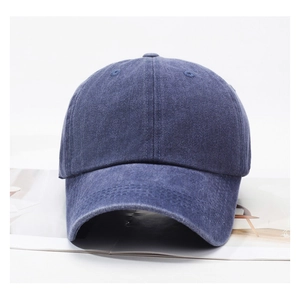 Close-up of a navy blue washed denim baseball cap on a clean white background