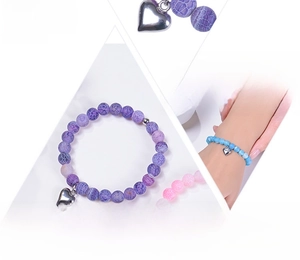 Detailed view of 8mm natural stone healing bracelets with metal heart charms on card
