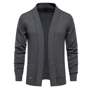 Detailed view of dark grey knitted cardigan featuring a leather logo patch on side pocket