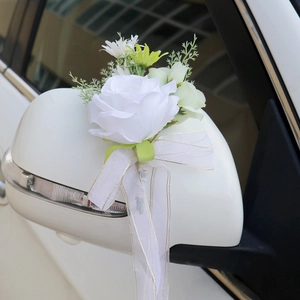 White silk wedding car mirror decoration featuring faux roses and elegant sheer ribbons