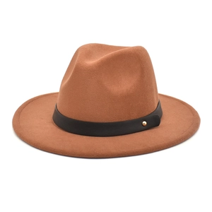 Detail of camel wool fedora with a black leather band and golden metal rivet accent