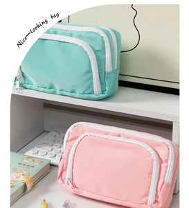 Front view of large capacity mint green and pink nylon pencil cases with double zippers