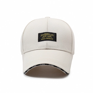 Beige cotton baseball cap with embroidered logo patch and lettered brim decoration