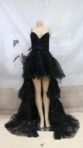 Detail of high-low black mesh evening gown with sparkling silver star sequins