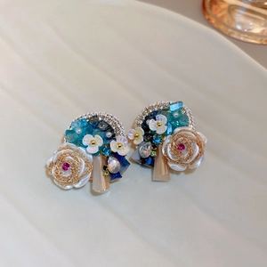 Baroque crystal flower earrings with silver needles and blue floral ornaments in detail