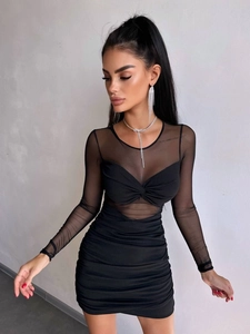 Detail of ruched black bodycon dress featuring mesh sleeves and sexy twist neckline