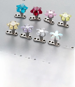 Detail of star-shaped zircon dermal anchor tops with stainless steel base and dimensions