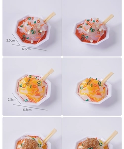 Macro detail of miniature food keychain model with size labels showing 6.3cm diameter bowl