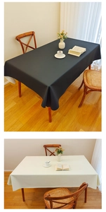 Detail of cream white and black waterproof leather tablecloth in a modern home setting