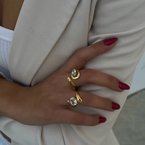 Golden irregular ring set with oval and marquise cut zircon stones for women