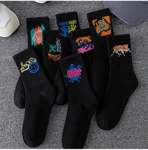 Detail of black cotton sports socks featuring colorful graffiti prints and ribbed texture